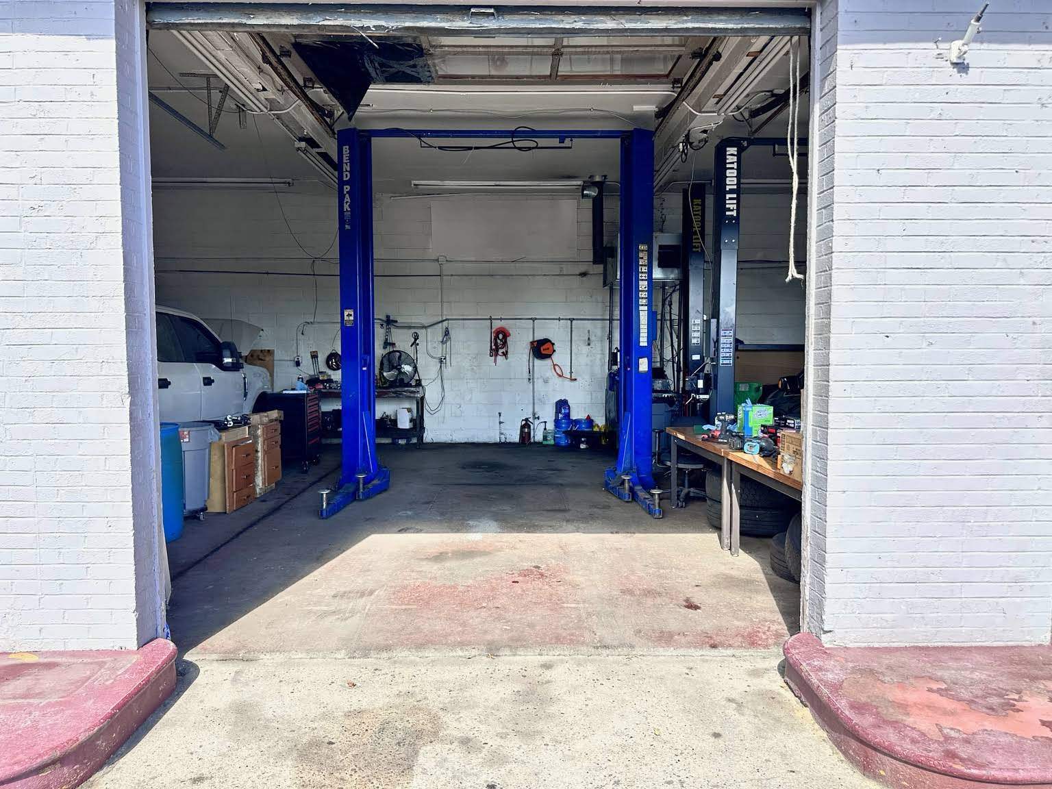 A vehicle lift inside the EXA Auto Motors workshop in Levittown